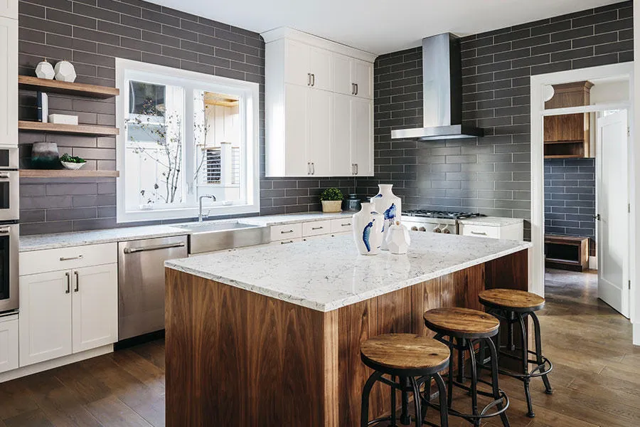 Modern kitchen remodel in Lexington Park MD by Advanced Kitchen Concepts featuring dark grey subway tile backsplash, walnut island with stools, and white cabinetry.